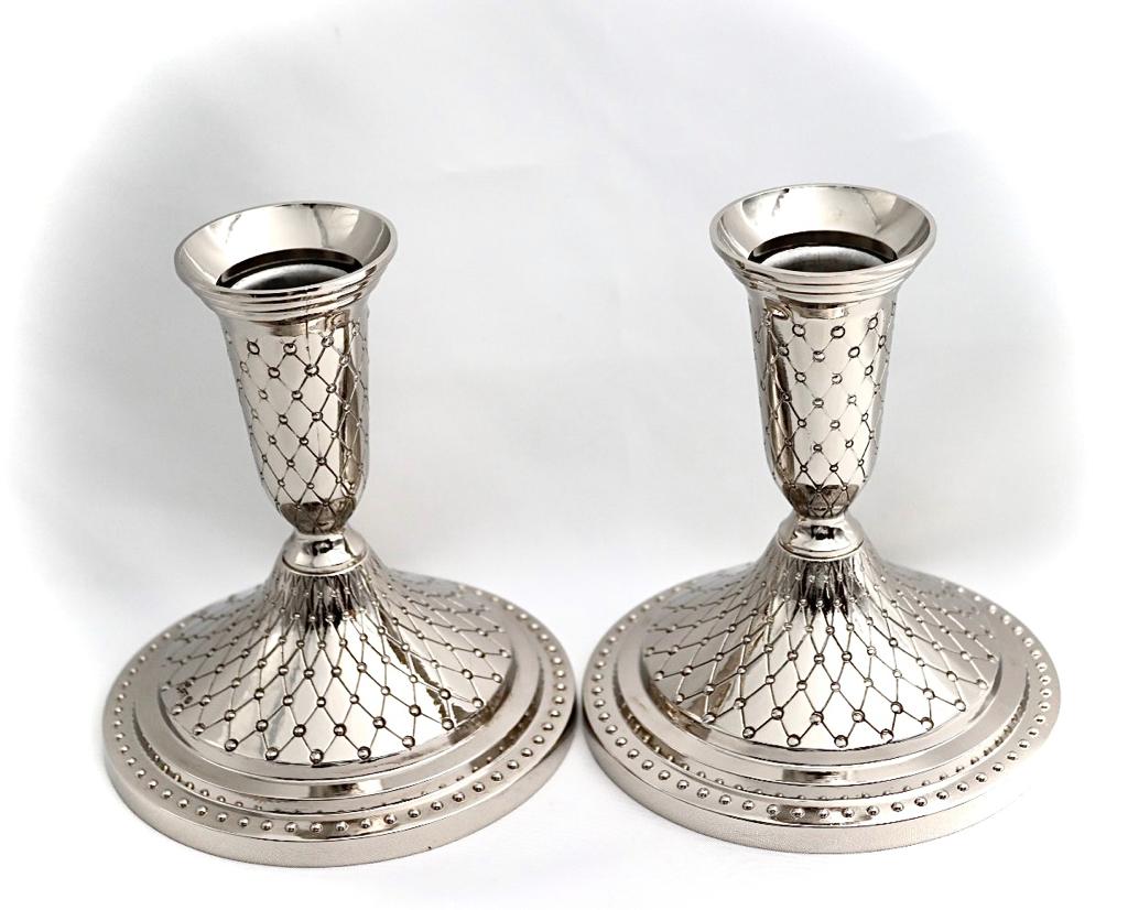 A pair of designed silver candlesticks