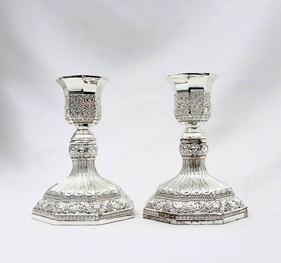 A pair of designed silver candlesticks