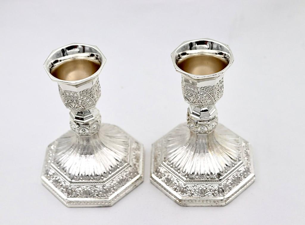 A pair of designed silver candlesticks