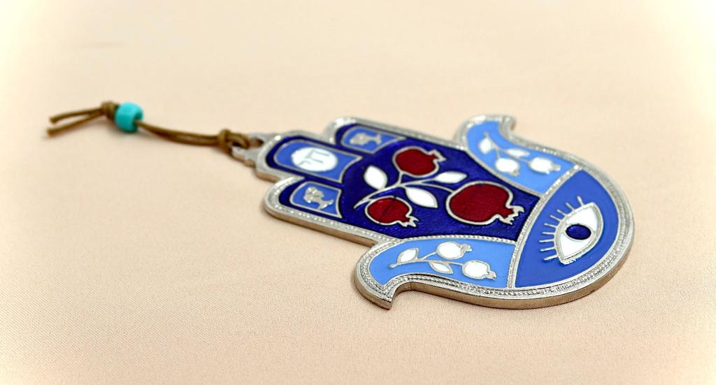 hamsa designed with pomegranate and an eye against the evil eye.