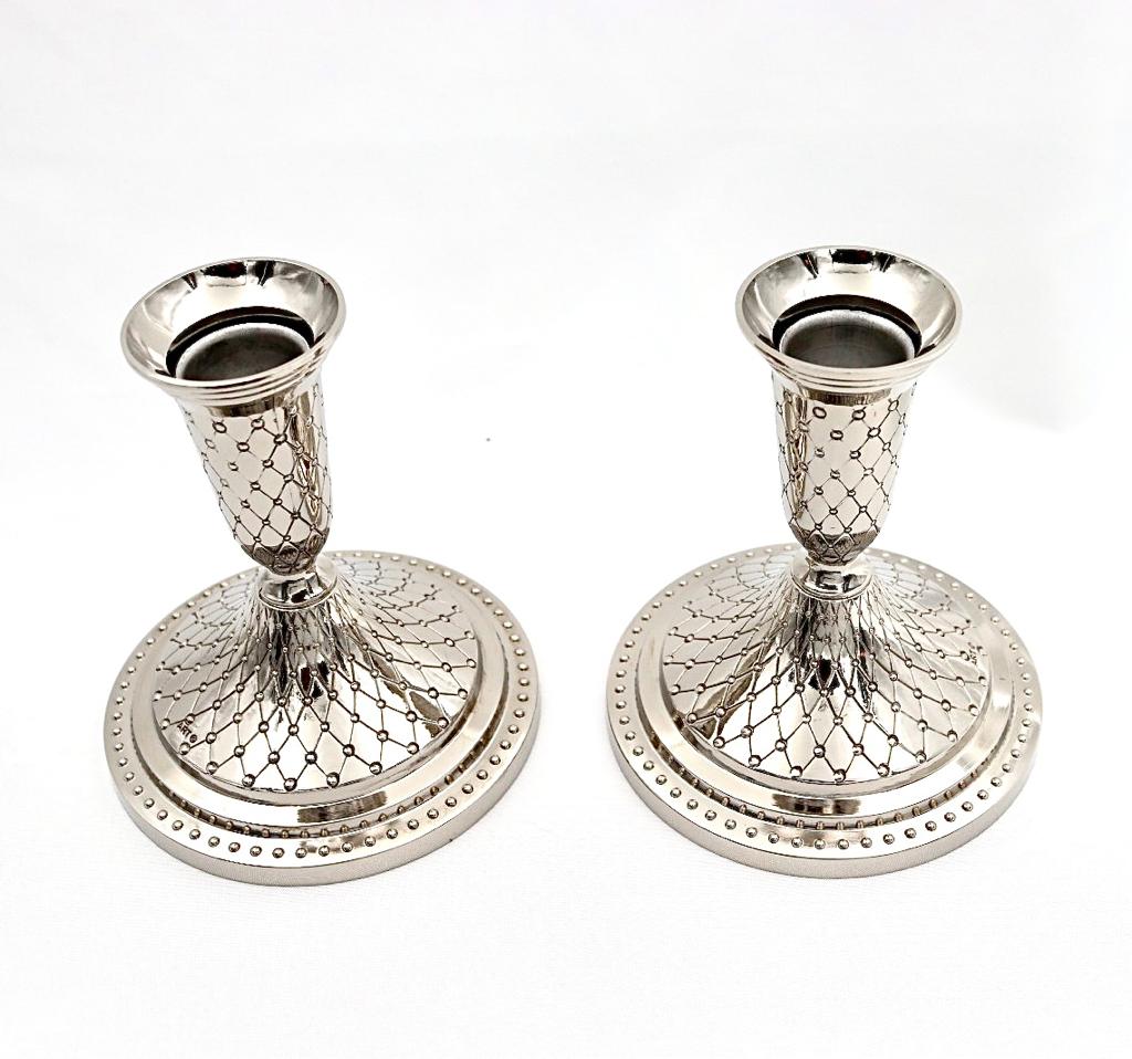 A pair of designed silver candlesticks
