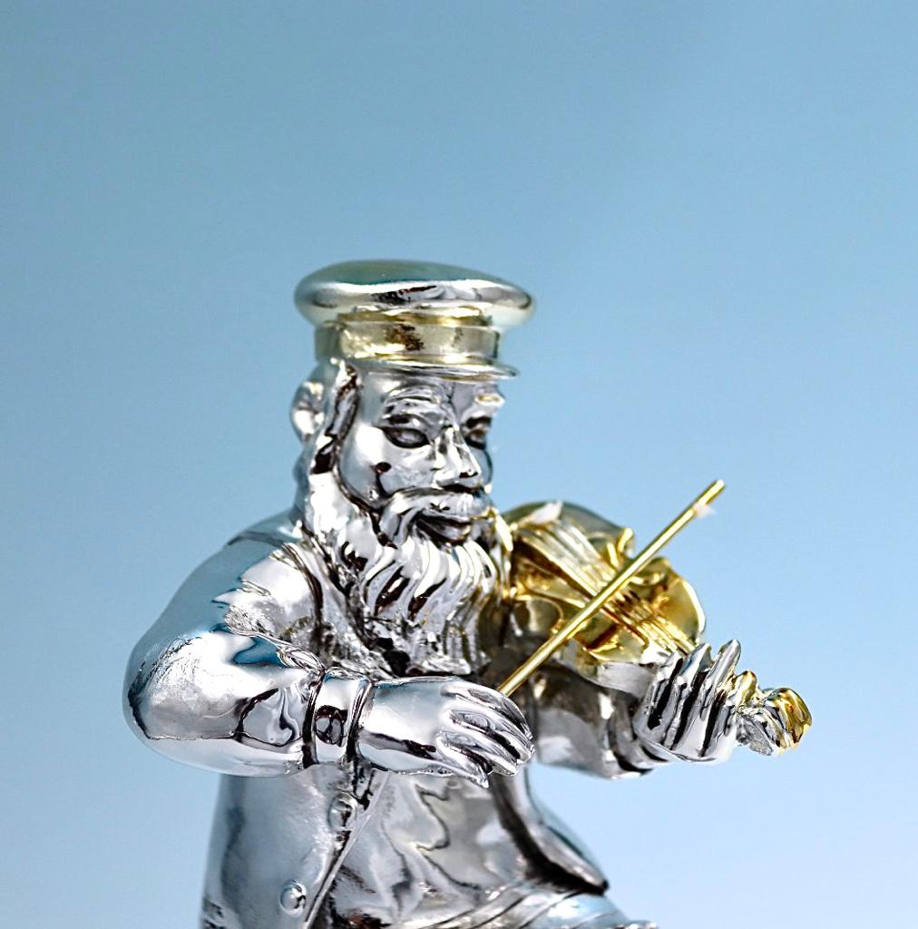 A seated Hasidic playing a violin, made of electroformed silver plating and gold plating.