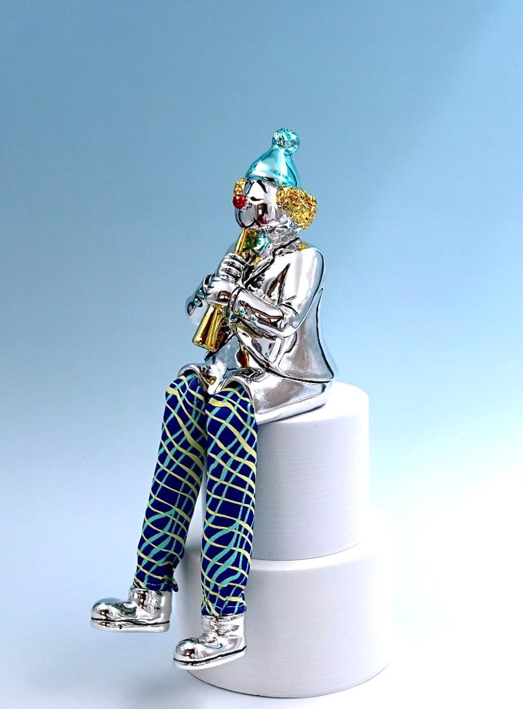 A seated clown plays the clarinet