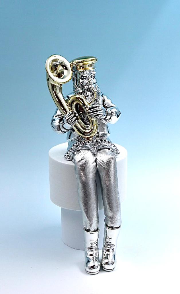 A Hasidic sits and plays a tuba