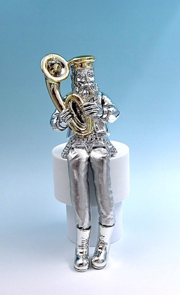A Hasidic sits and plays a tuba