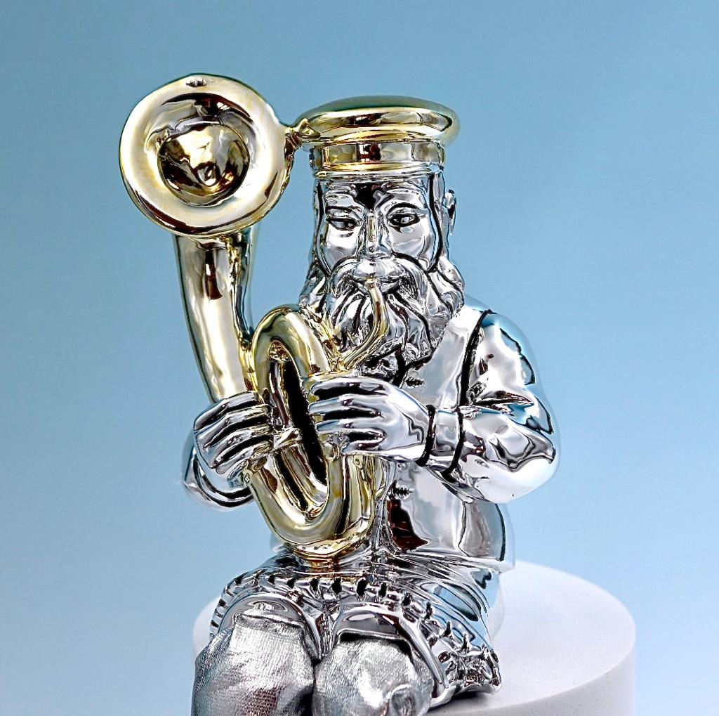 A Hasidic sits and plays a tuba