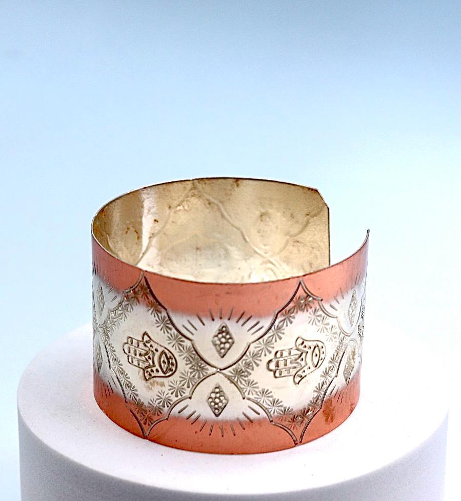 copper bracelet with silver engraved with Hamsa.