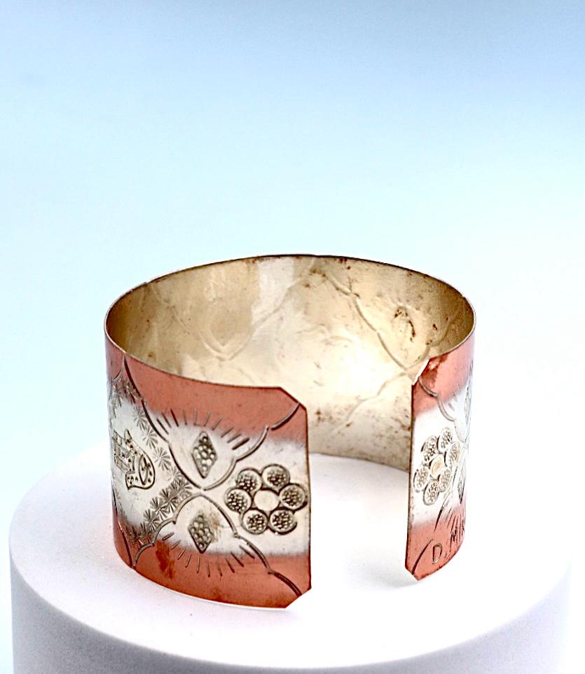 copper bracelet with silver engraved with Hamsa.