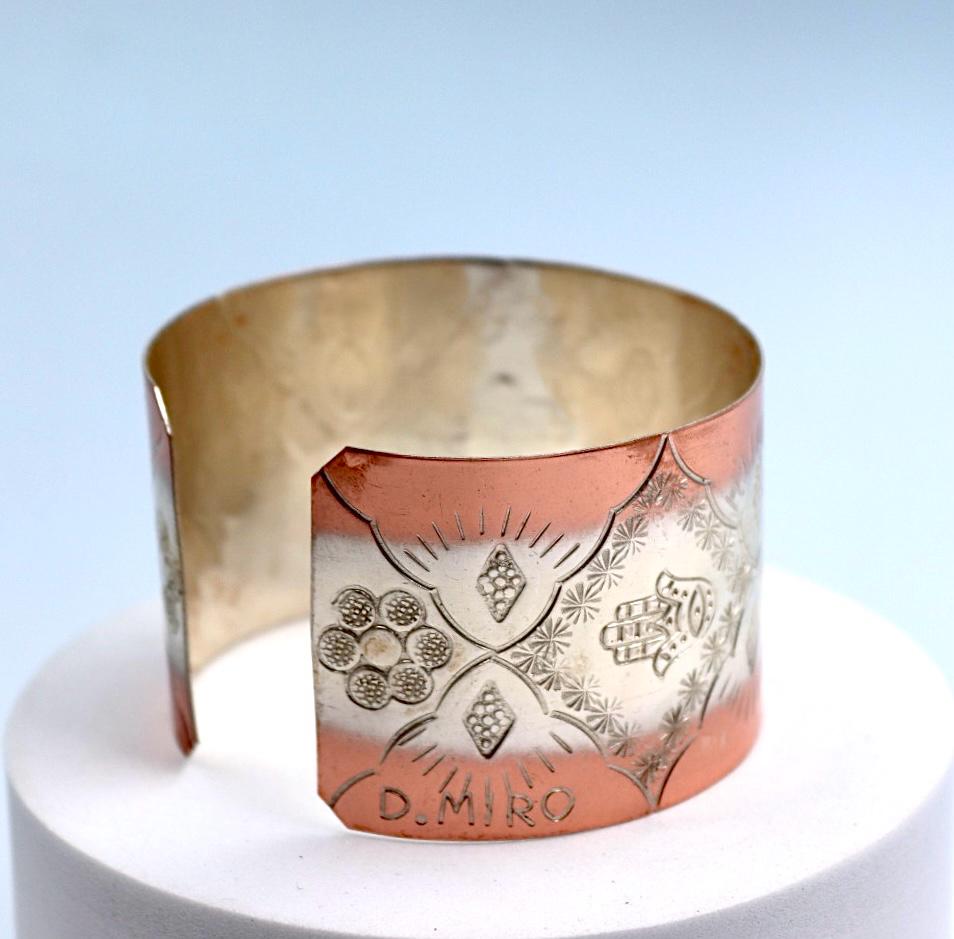 copper bracelet with silver engraved with Hamsa.