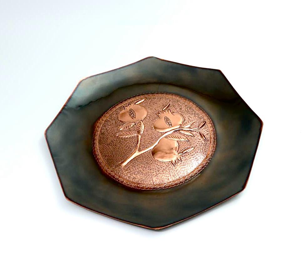 Copper hammering of pomegranates, partially blackened