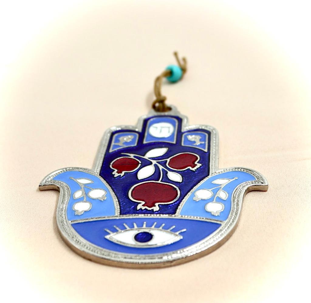 hamsa designed with pomegranate and an eye against the evil eye.