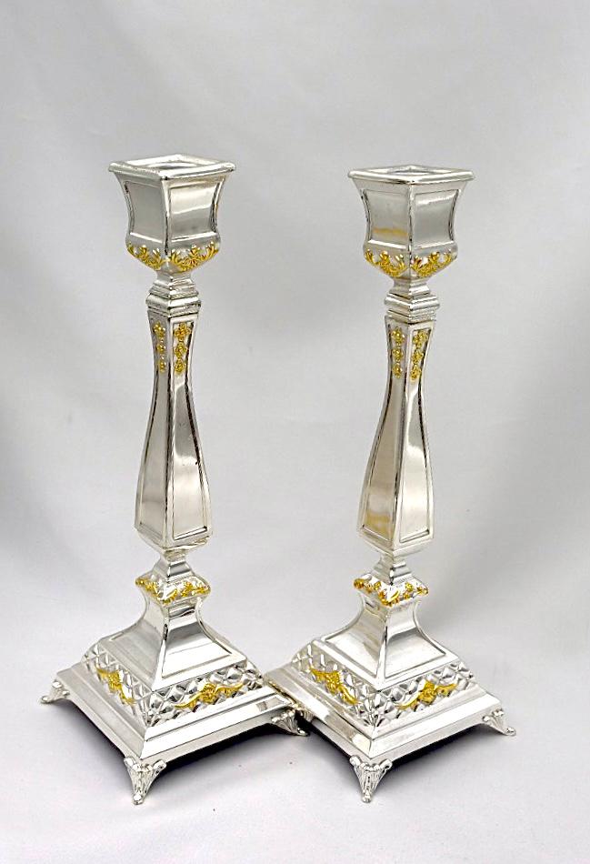 A pair of designed silver candlesticks