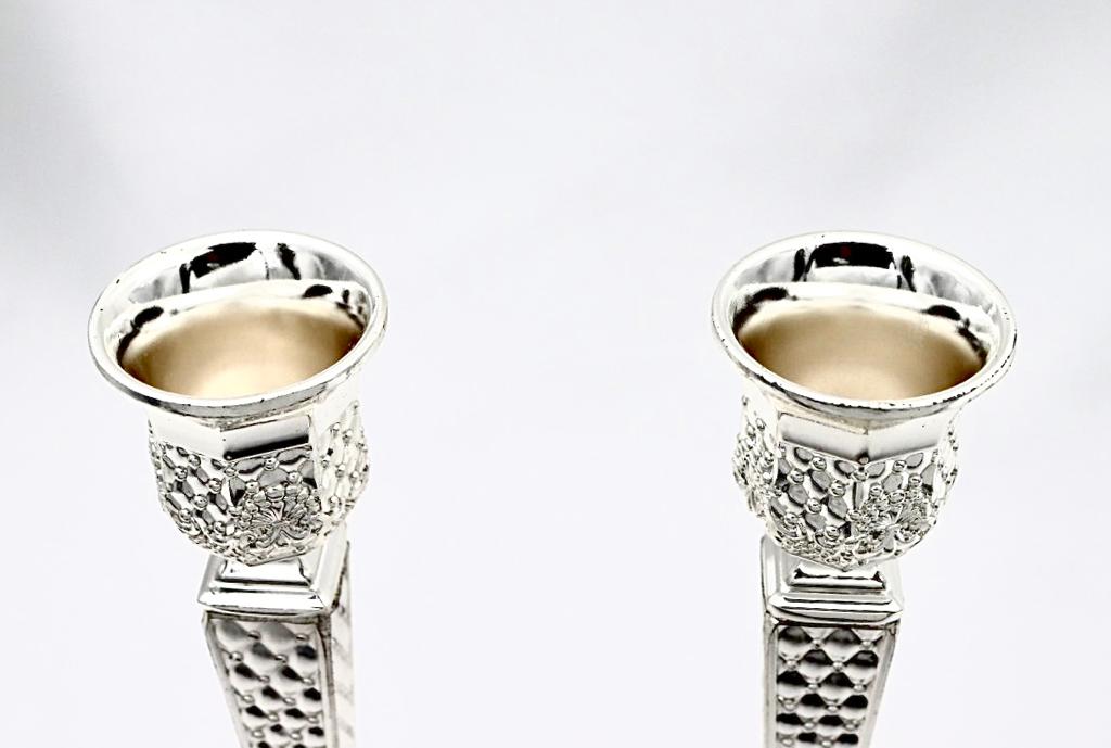 A pair of designed silver candlesticks