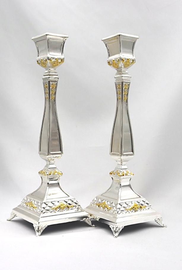 A pair of designed silver candlesticks