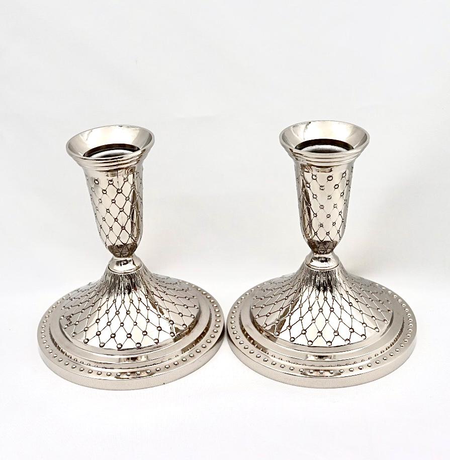 A pair of designed silver candlesticks