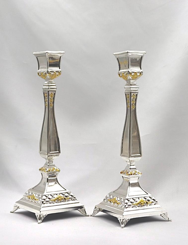 A pair of designed silver candlesticks