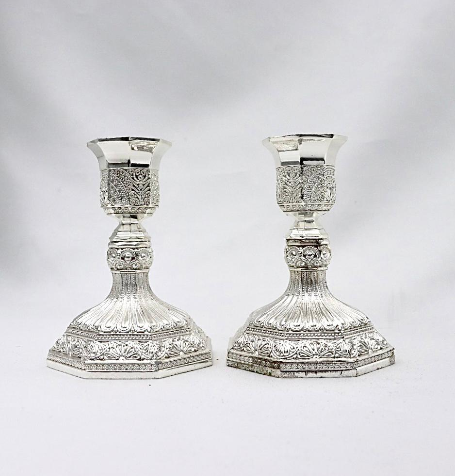 A pair of designed silver candlesticks