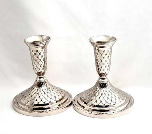 A pair of designed silver candlesticks