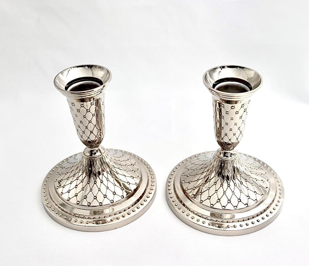 A pair of designed silver candlesticks