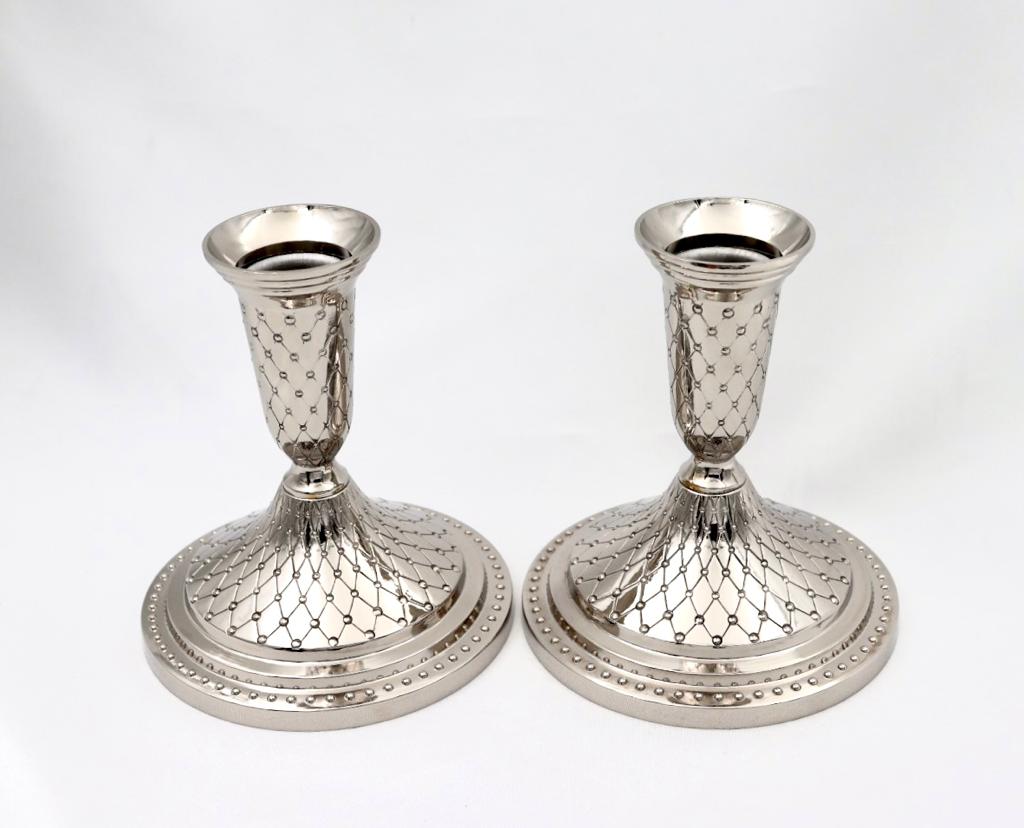 A pair of designed silver candlesticks