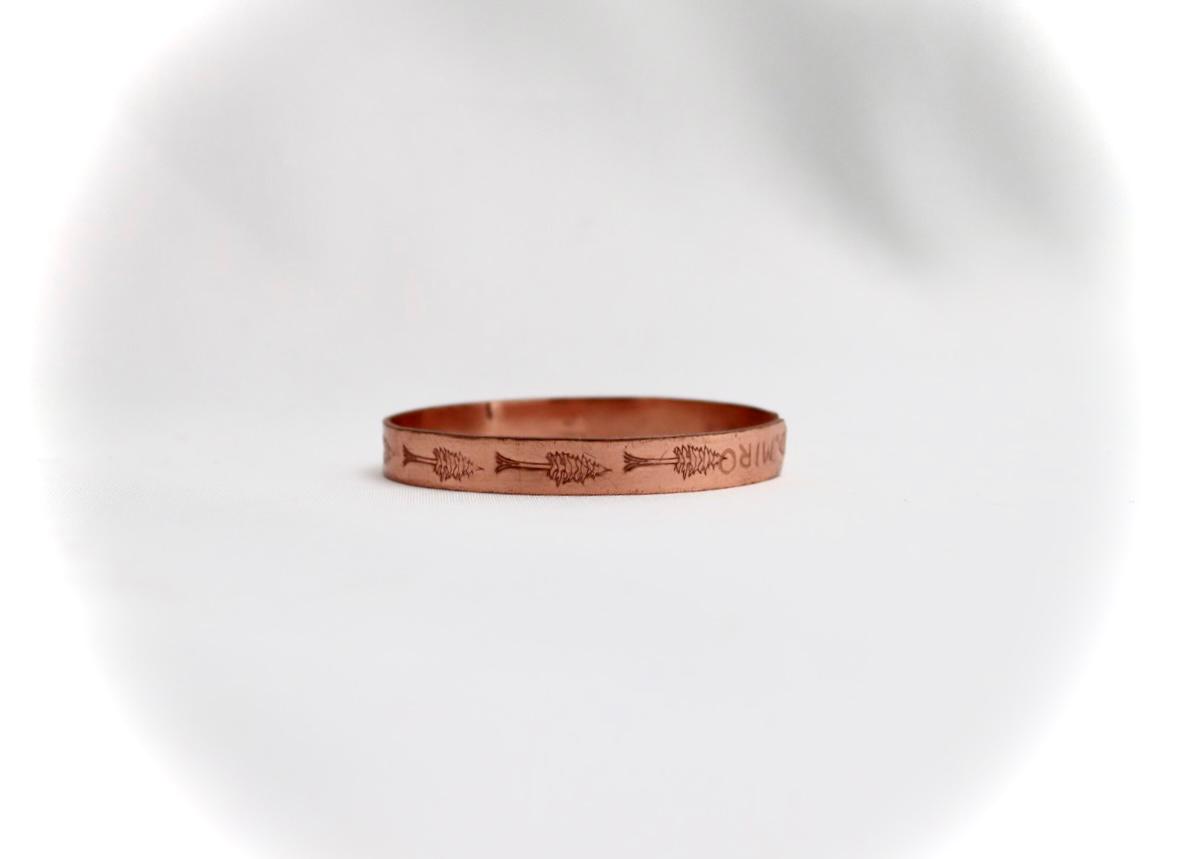 copper bracelet with a cypress design