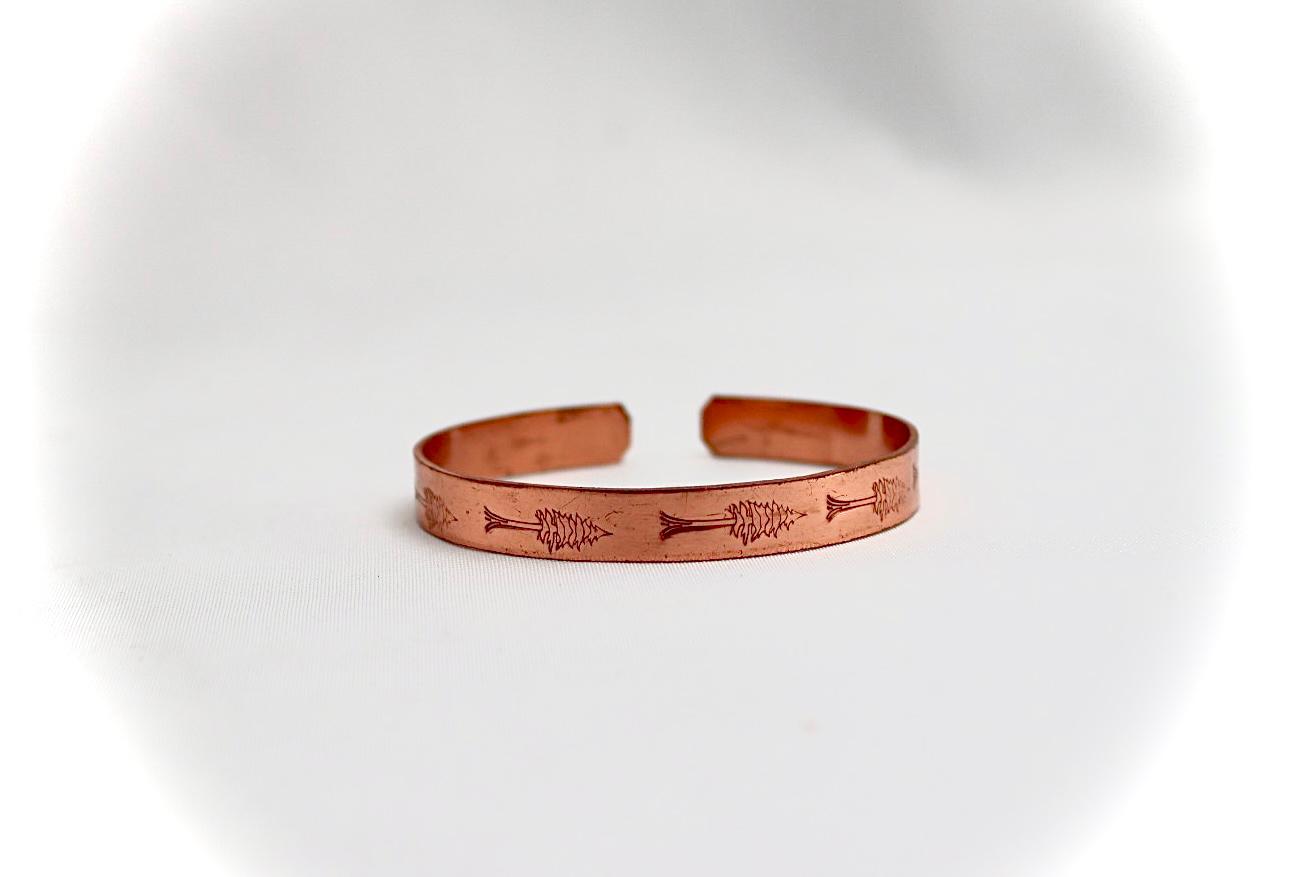 copper bracelet with a cypress design