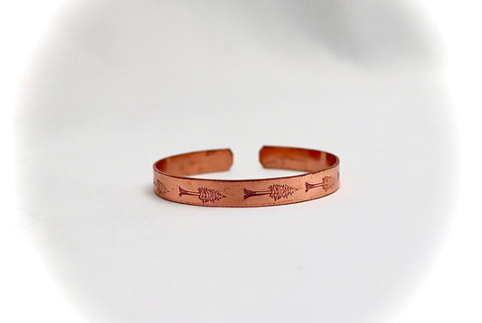 copper bracelet with a cypress design