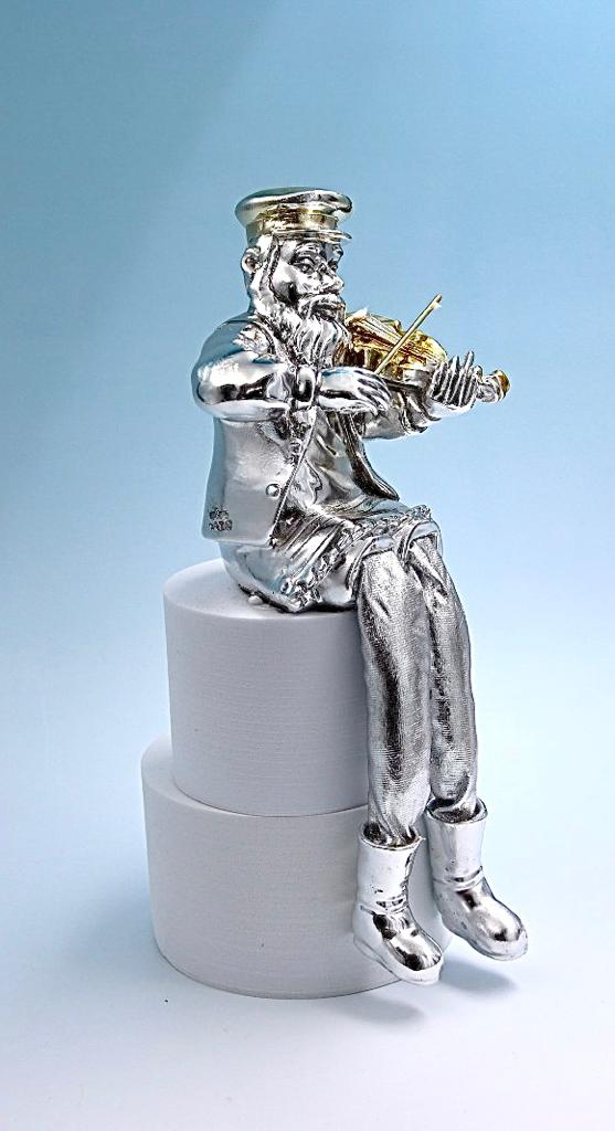 A seated Hasidic playing a violin, made of electroformed silver plating and gold plating.