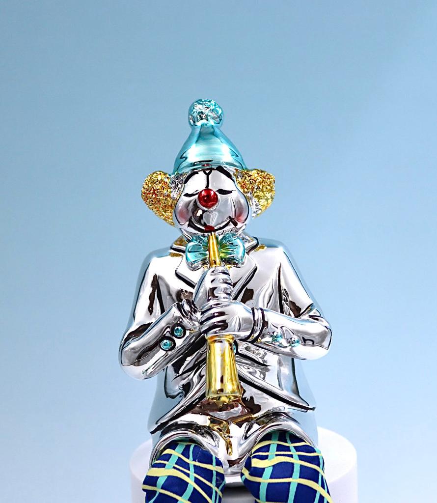 A seated clown plays the clarinet