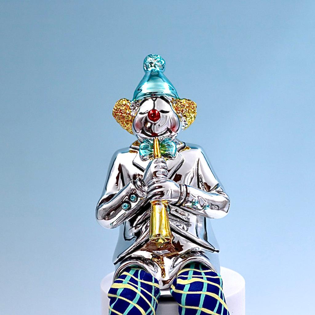 A seated clown plays the clarinet