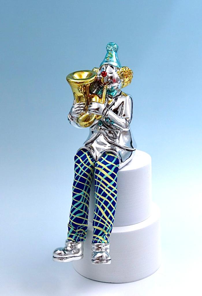 A seated clown plays the tuba