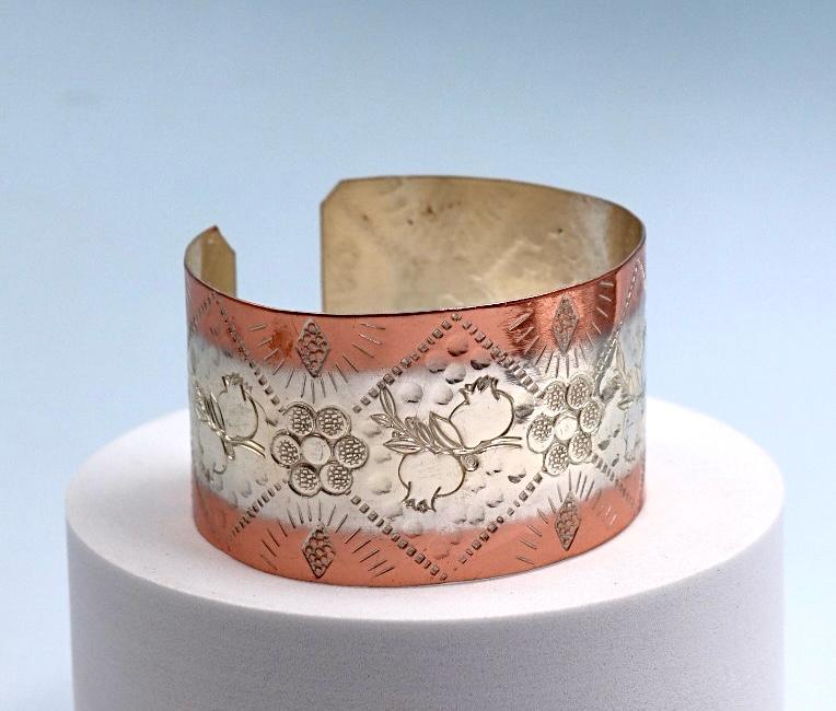 Copper and silver bracelet with pomegranate design