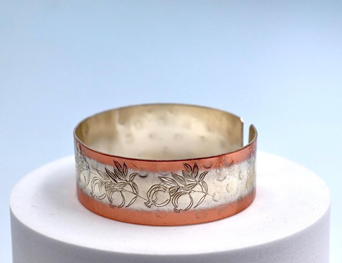 copper bracelet with silver engraved with pomegranates