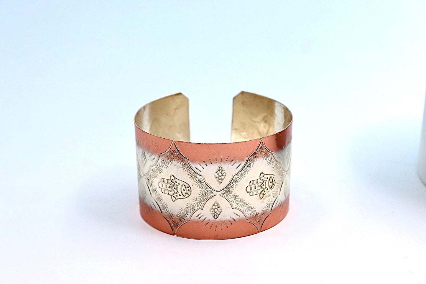 copper bracelet with silver engraved with Hamsa.