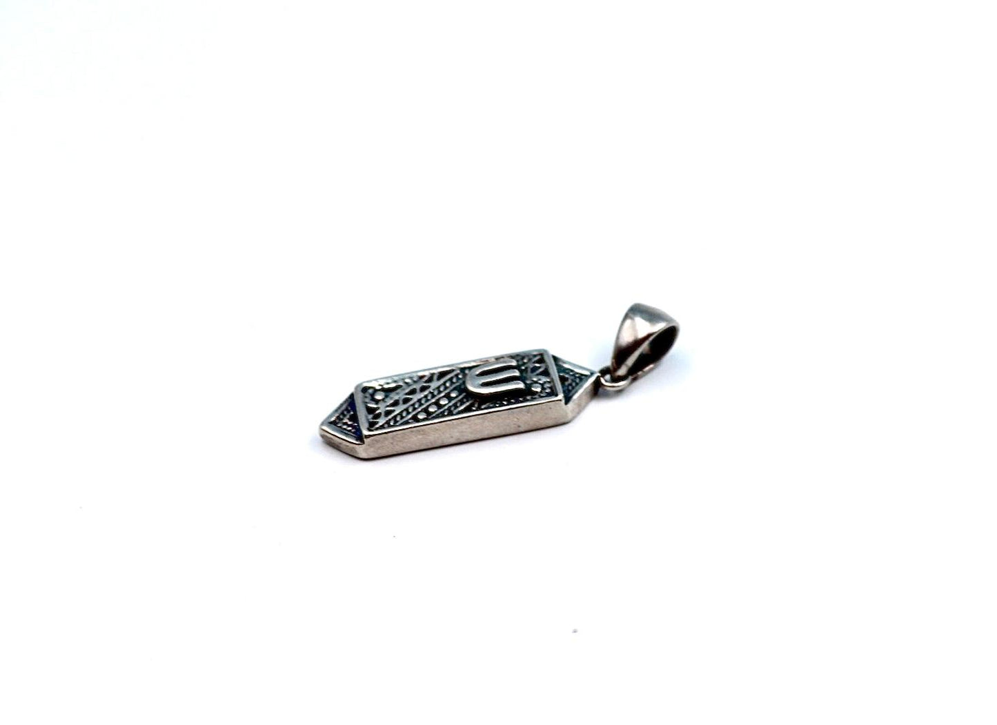 silver pendant resembling a mezuzah.