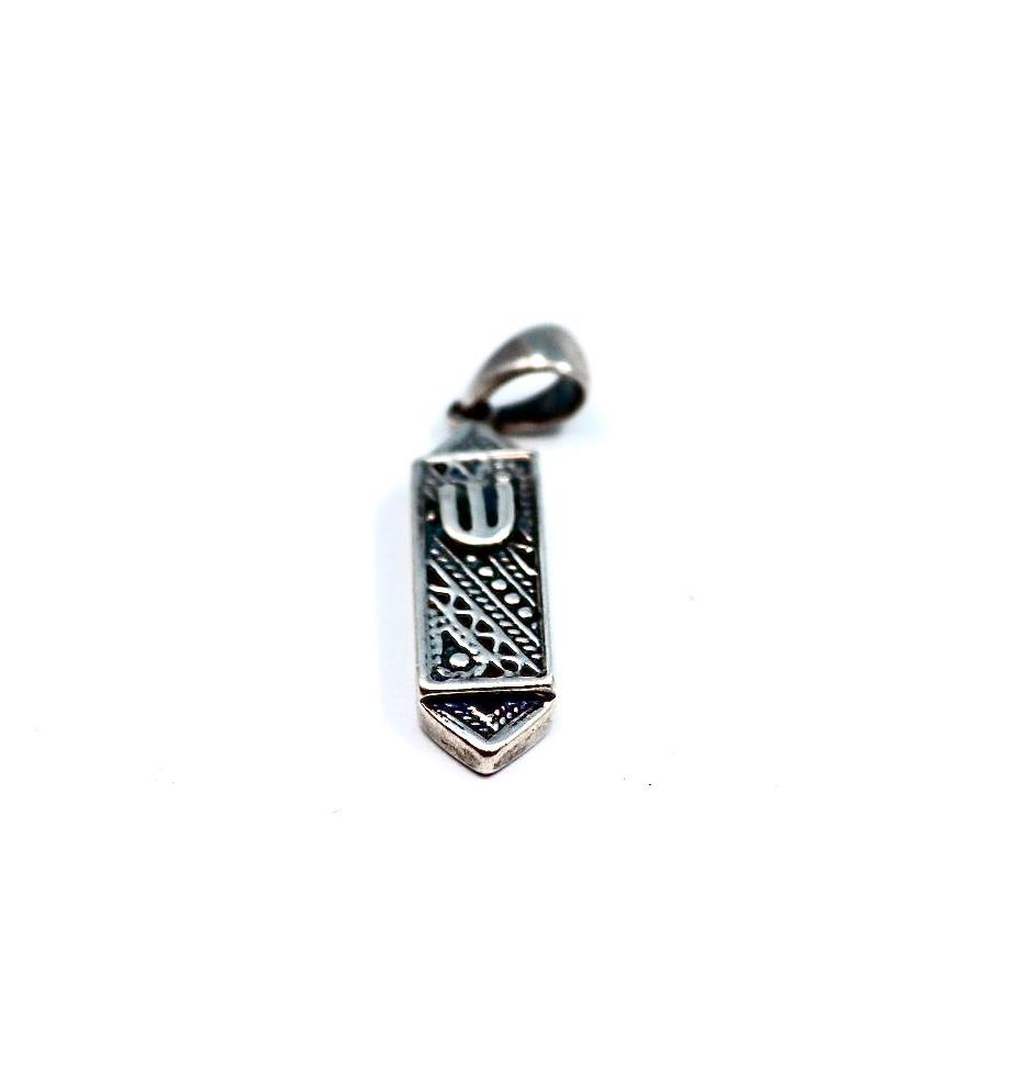 silver pendant resembling a mezuzah.