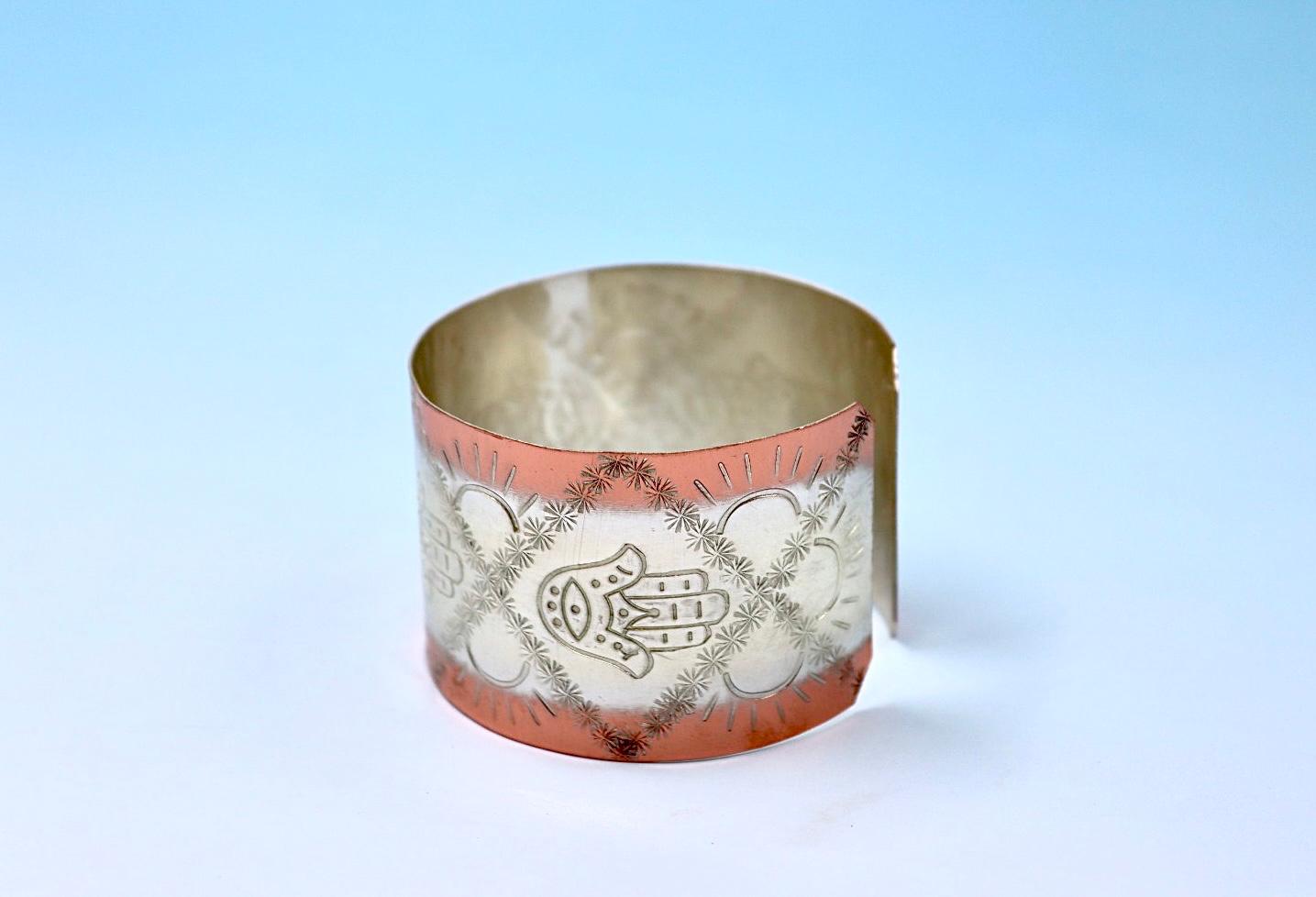 copper bracelet with Hamsa, partly silver plated.