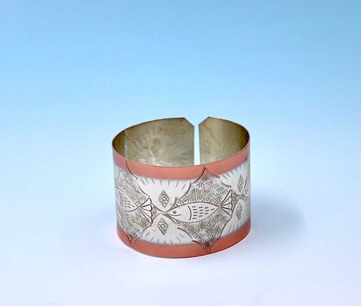 copper bracelet with A Fish design, partly silver-plated.