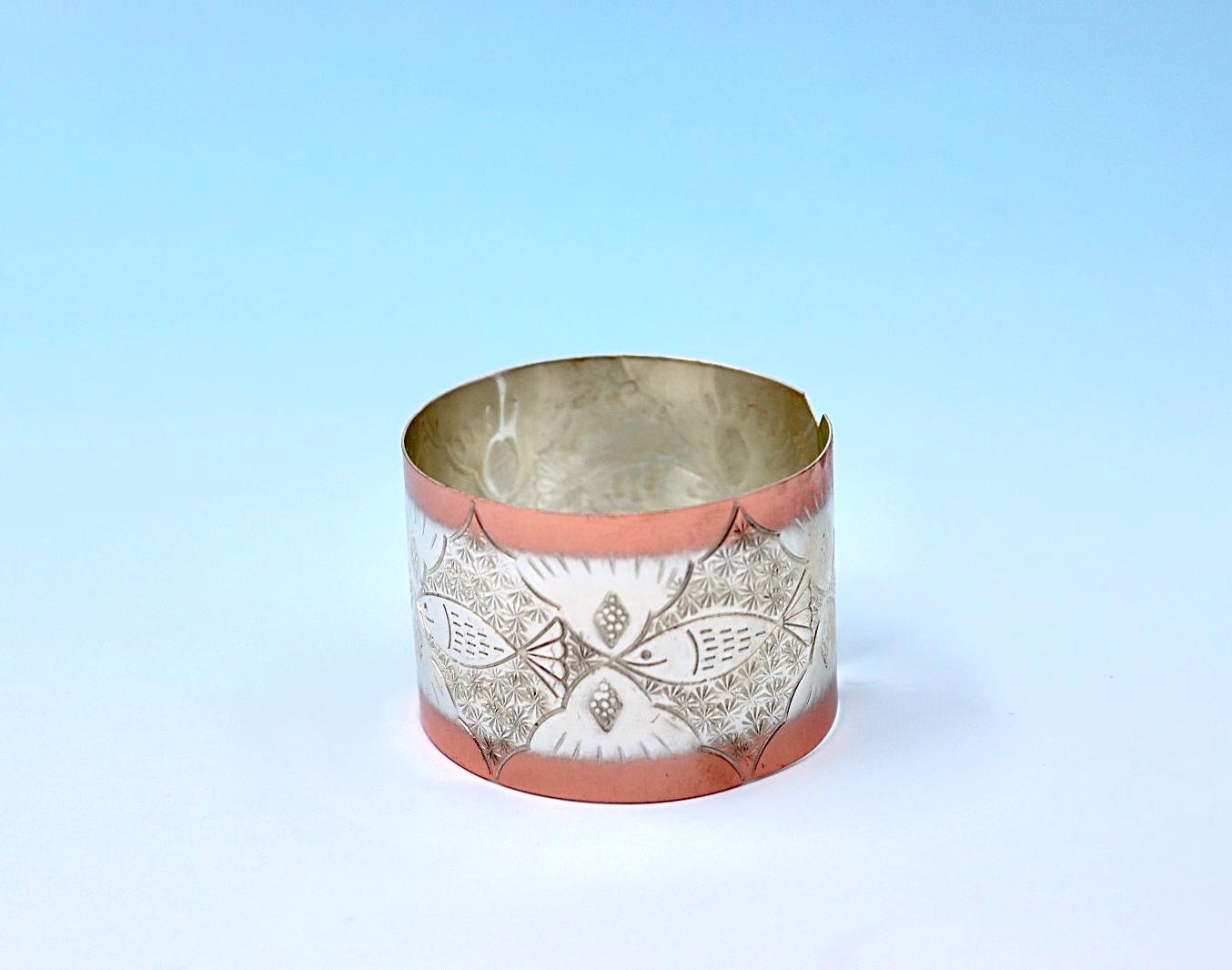 copper bracelet with A Fish design, partly silver-plated.