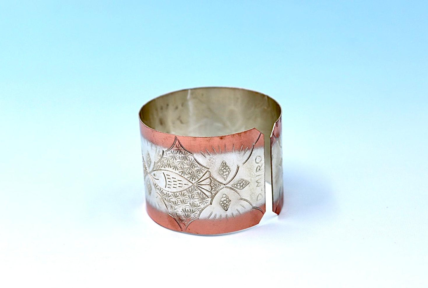 copper bracelet with A Fish design, partly silver-plated.