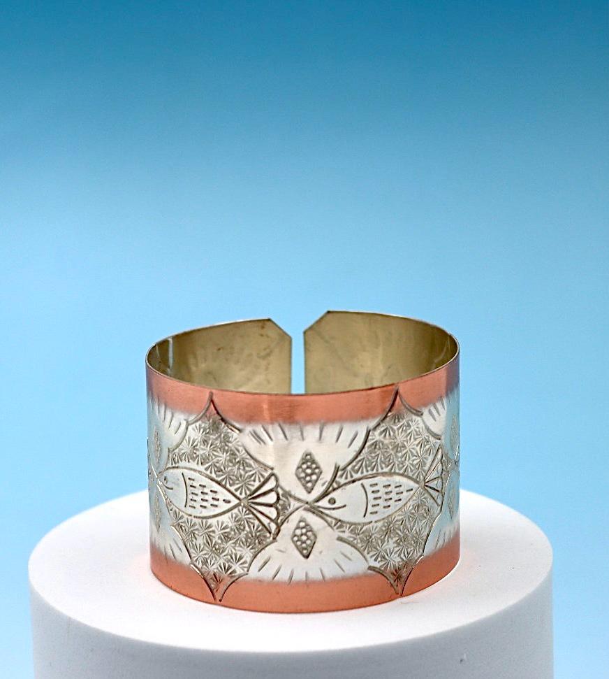 copper bracelet with A Fish design, partly silver-plated.