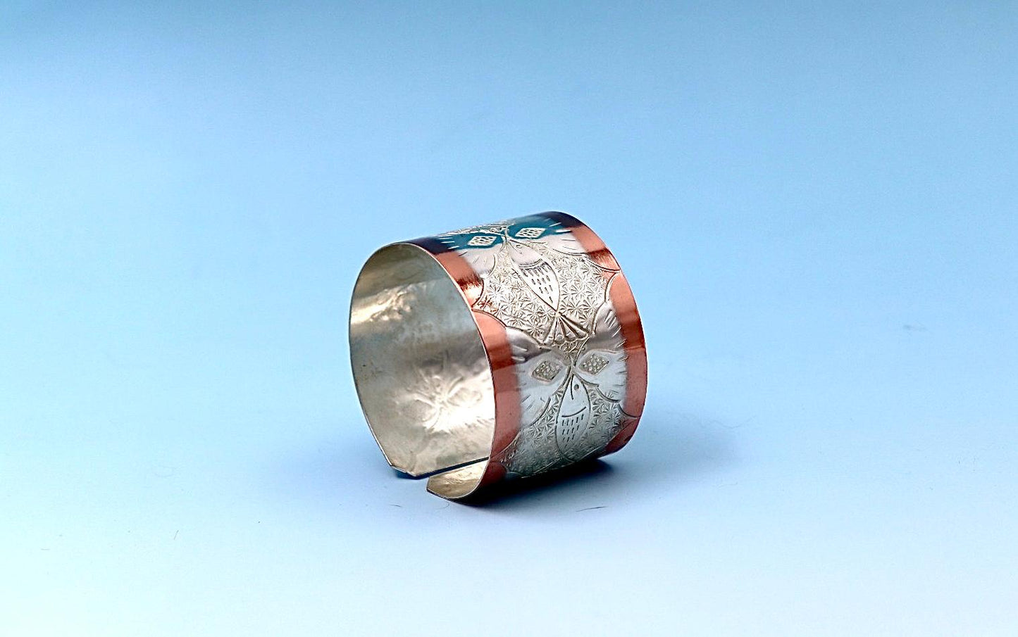 copper bracelet with A Fish design, partly silver-plated.