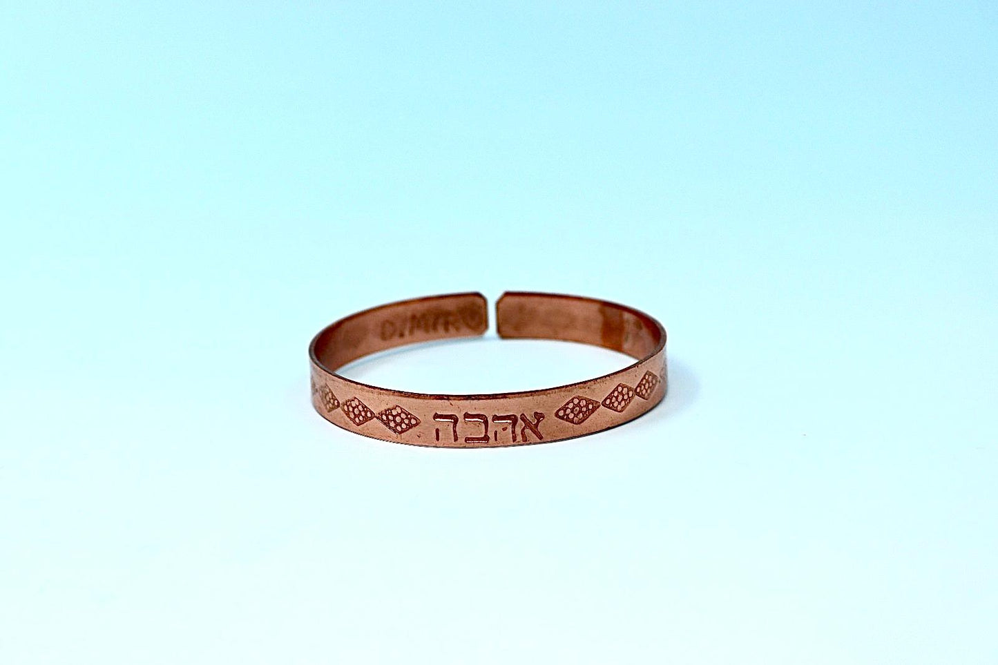 copper bracelet written:״LOVE ״ in Hebrew