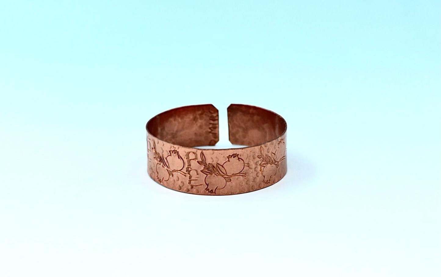 copper bracelet with hamsa.