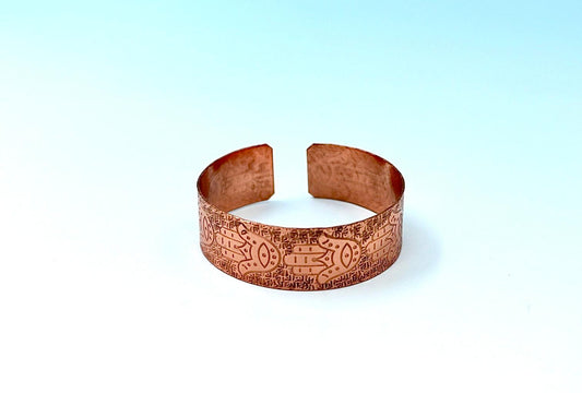 copper bracelet with hamsa.