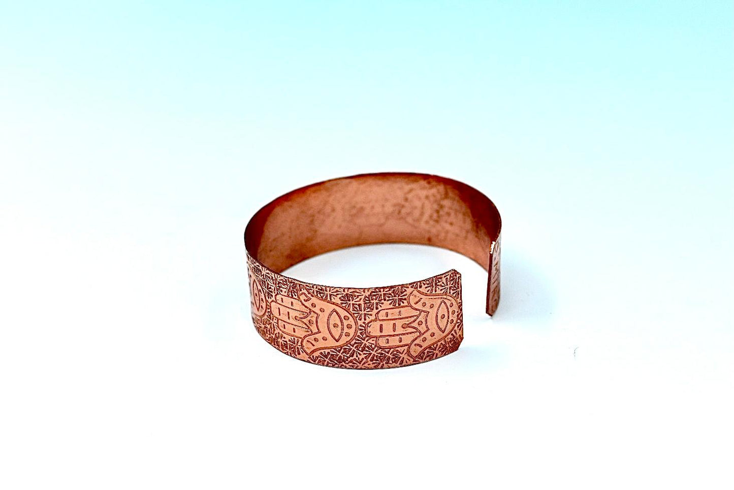 copper bracelet with hamsa.