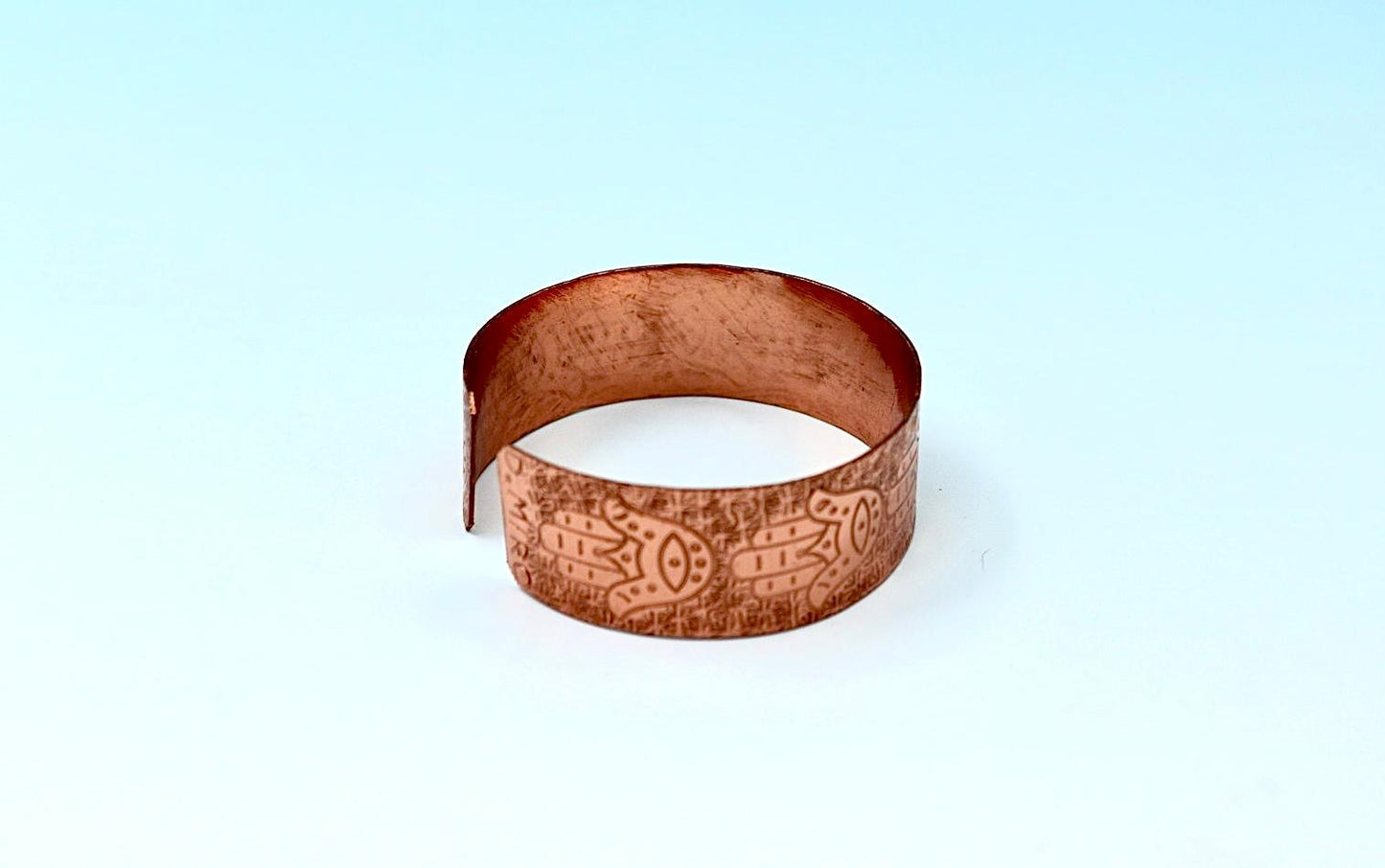 copper bracelet with hamsa.