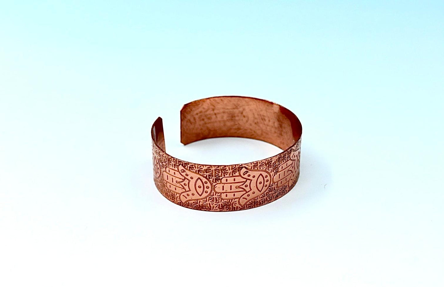 copper bracelet with hamsa.