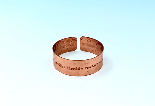 copper bracelet engraved with  seven blessings.