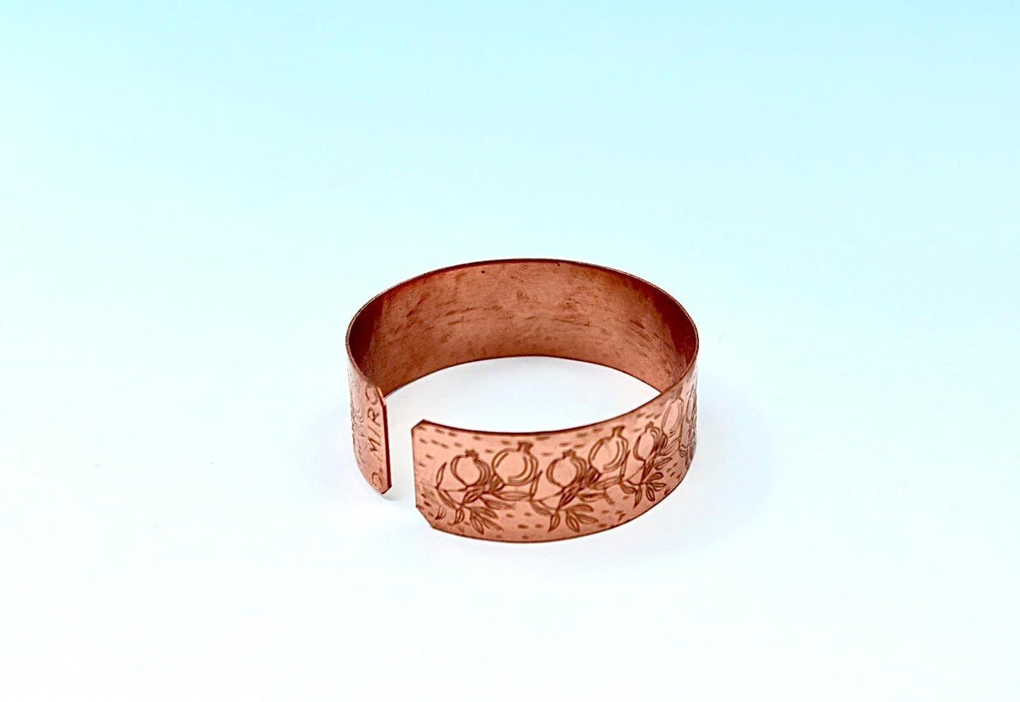 copper bracelet engraved with pomegranates